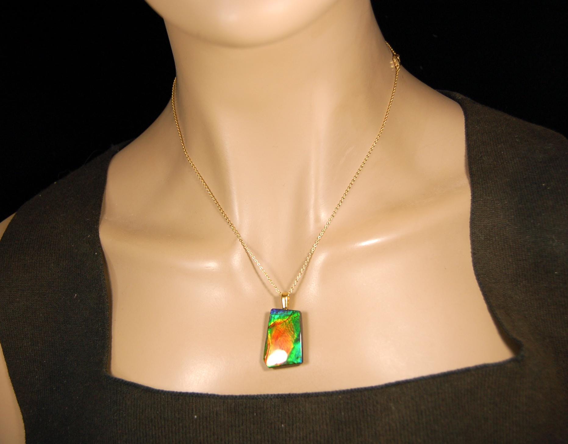 Ammolite pendant.Vivid colors in a high quality all natural cabochon with 14k gold filled bail.Fine fashion jewelry accessory 022516
