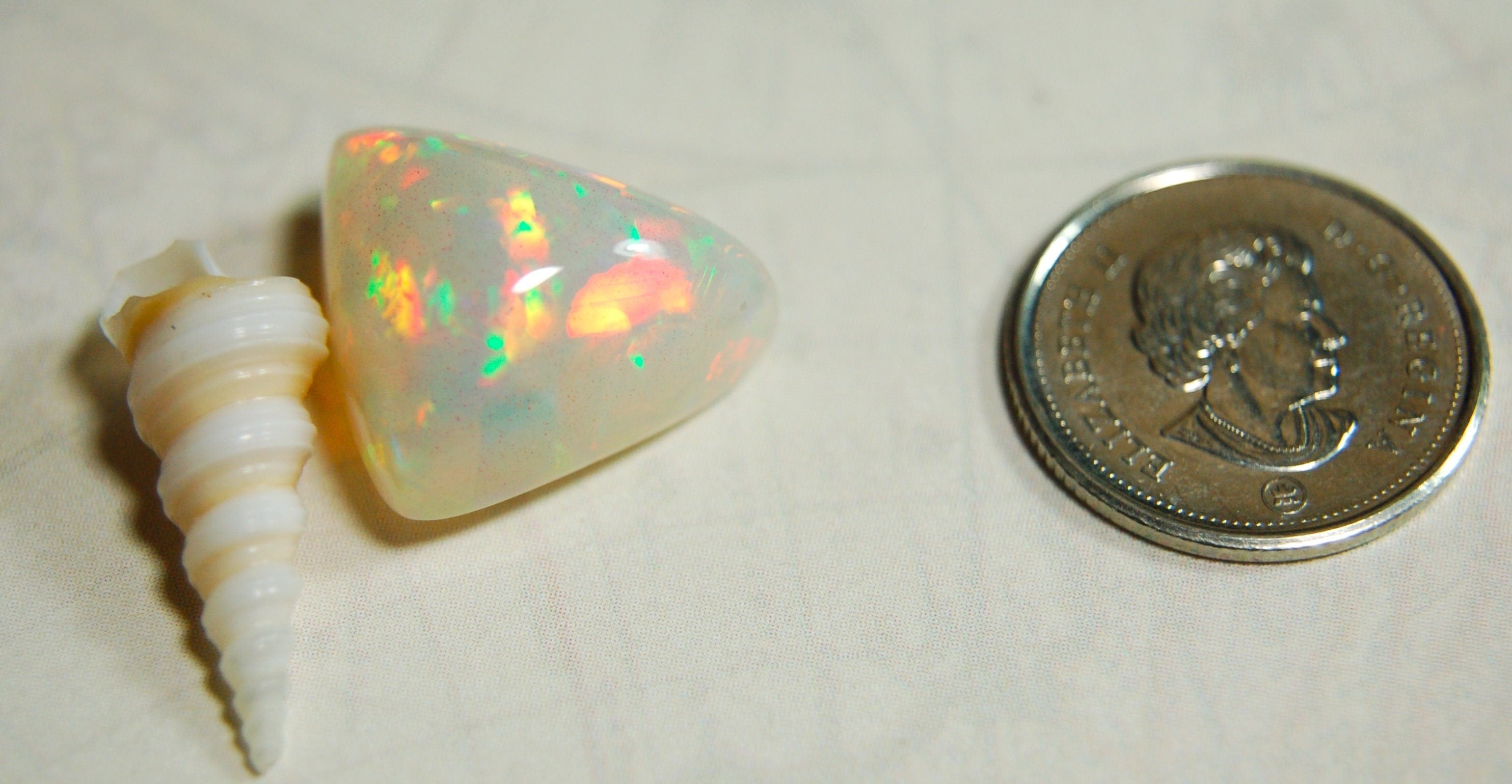 Large genuine natural Opal Cabochon from Ethiopia.11 Carat beauty with many bright colors.Best viewed in video--better in hand.122813