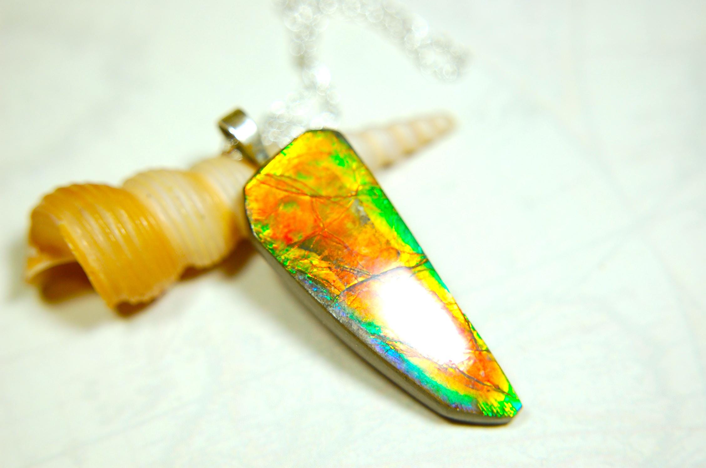 Ammolite necklace pendant.Natural rainbow cabochon of many bright colors.Strong color shifter.Video shows color best.030116