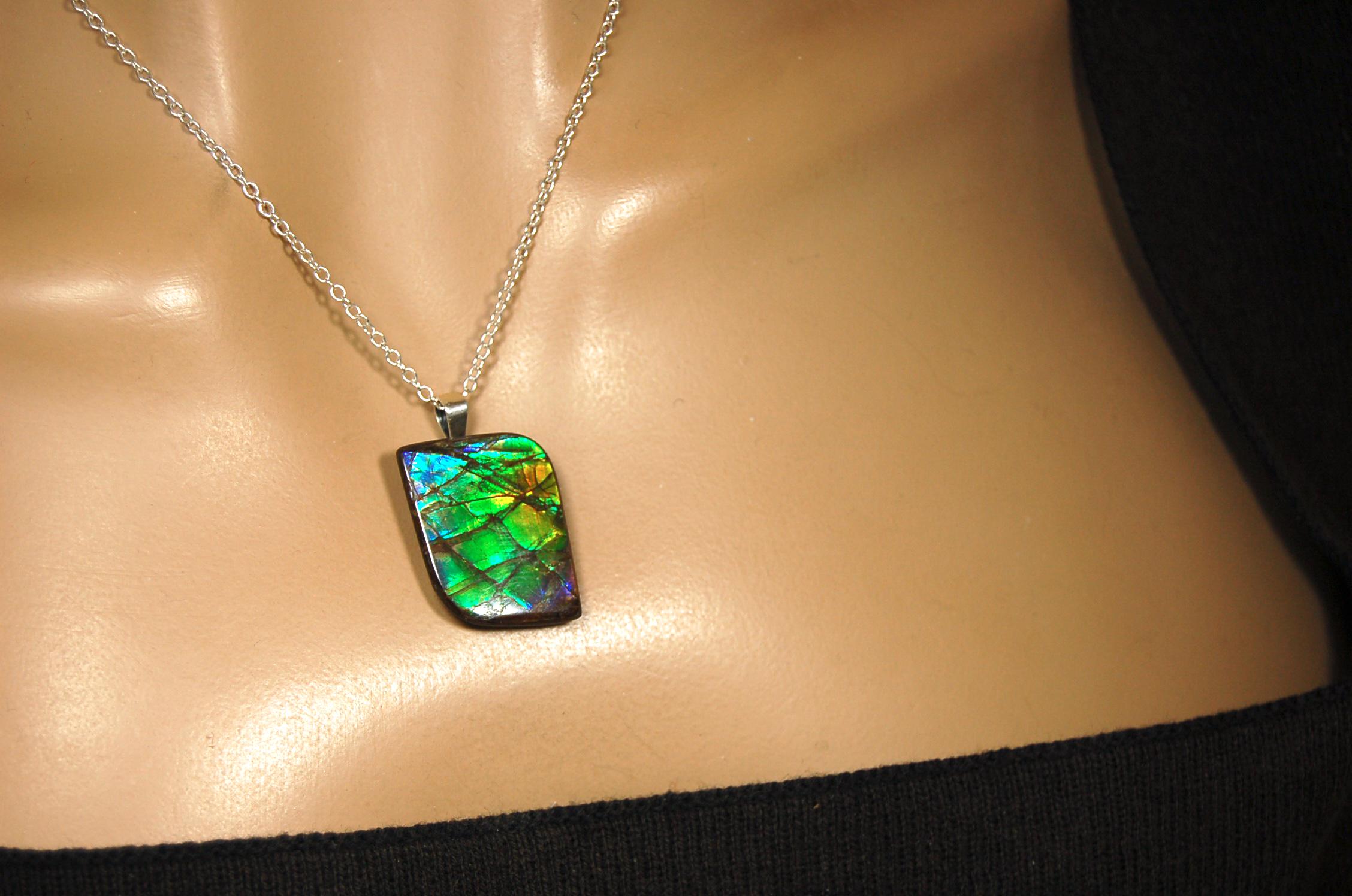 Ammolite Jewelry Pendant.Very high quality colors best seen in video.All natural cabochon gemstone from Alberta,Canada.031916