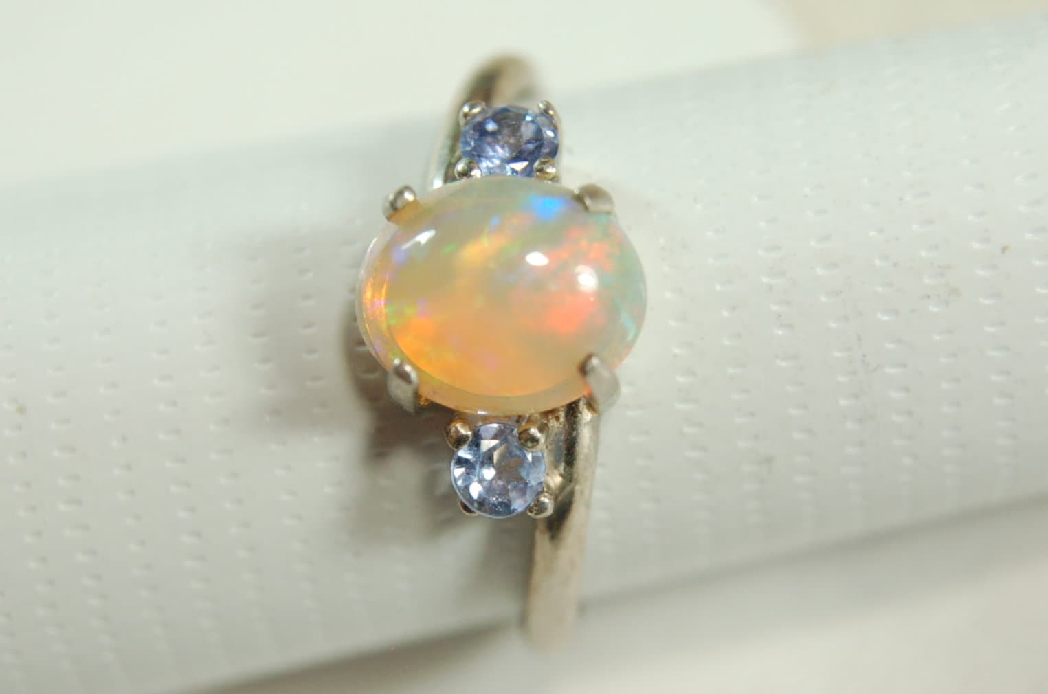 Opal ring.Solid African opal set in sterling silver with London Blue Topaz accent stones.Very feminine in size 6.