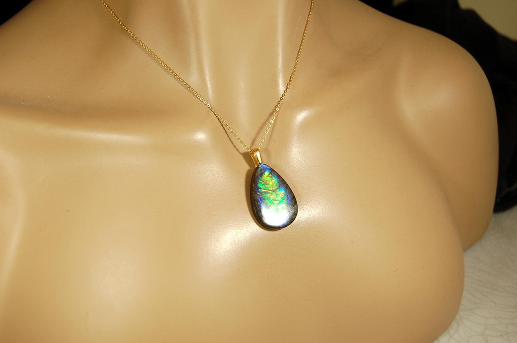 Ammolite Pendant with peacock colors.Natural cabochon gemstone mined and shipped from Canada.Gift of unique jewelry..020926