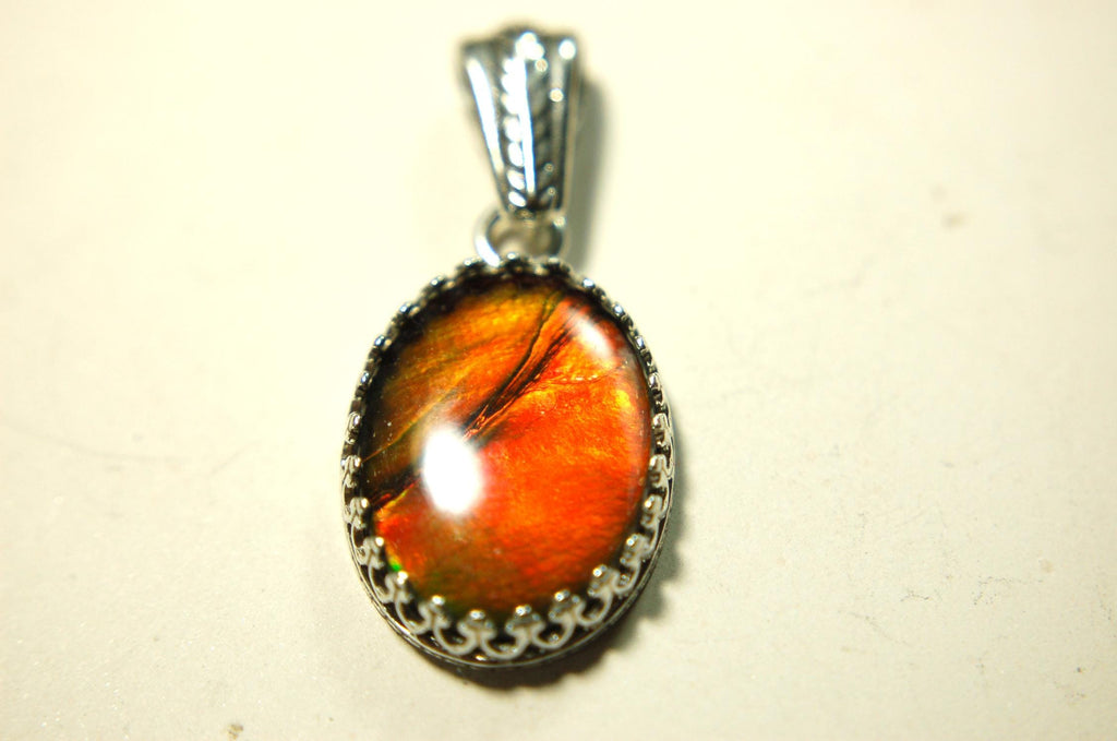 Ammolite Pendant Necklace.Resembles a fiery coal.Strong color shifter.Duty free under CUSMA rules.022115