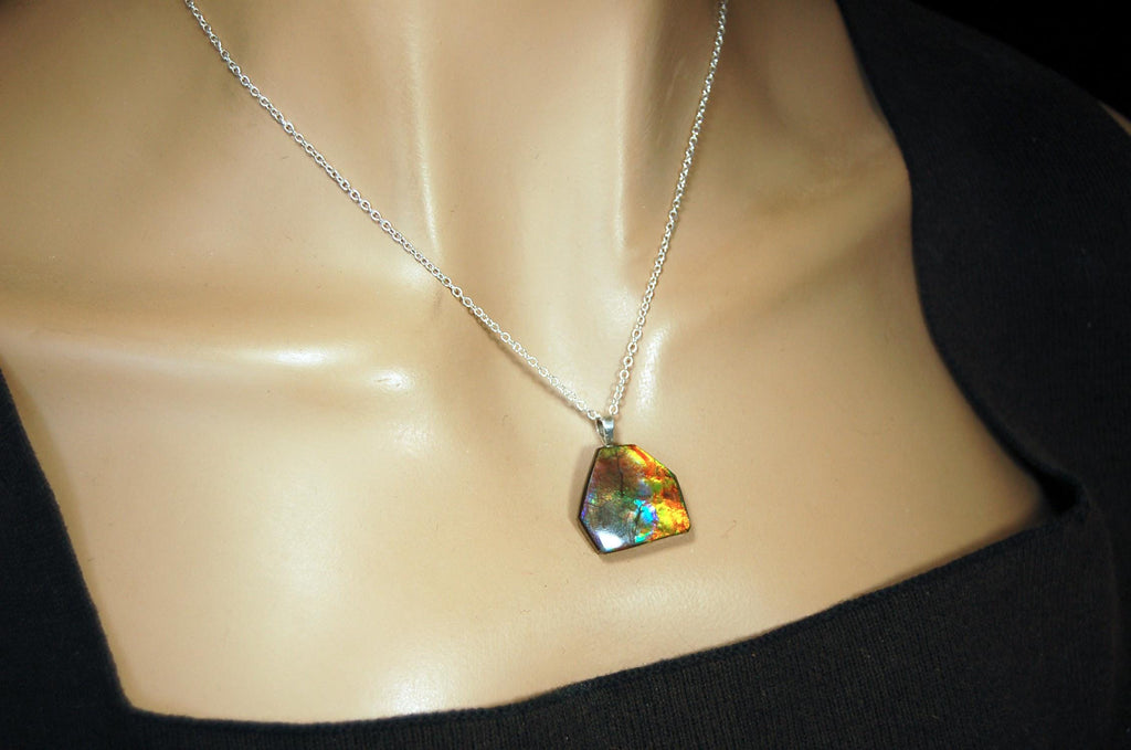 Ammolite pendant.RARE colors.Best seen in video.All natural cabochon from Alberta Canada.Thoughtful gift for her.022716