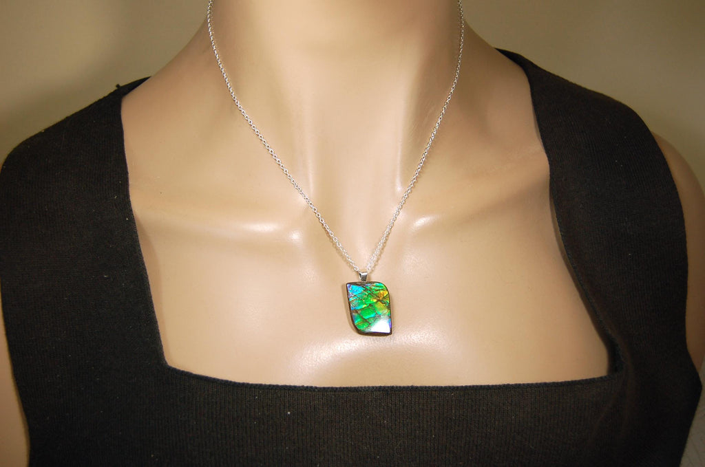 Ammolite Jewelry Pendant.Very high quality colors best seen in video.All natural cabochon gemstone from Alberta,Canada.031916