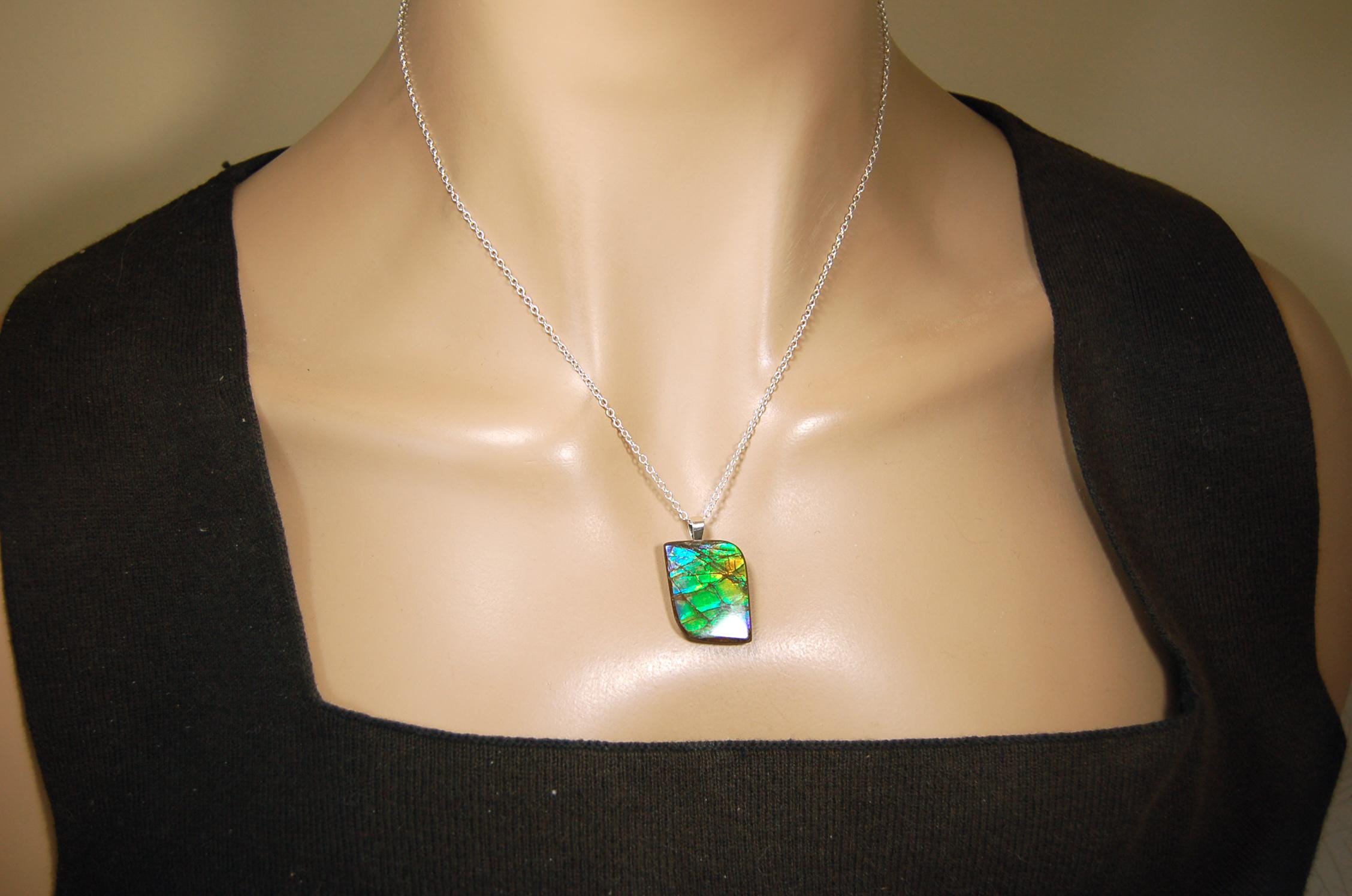 Ammolite Jewelry Pendant.Very high quality colors best seen in video.All natural cabochon gemstone from Alberta,Canada.031916