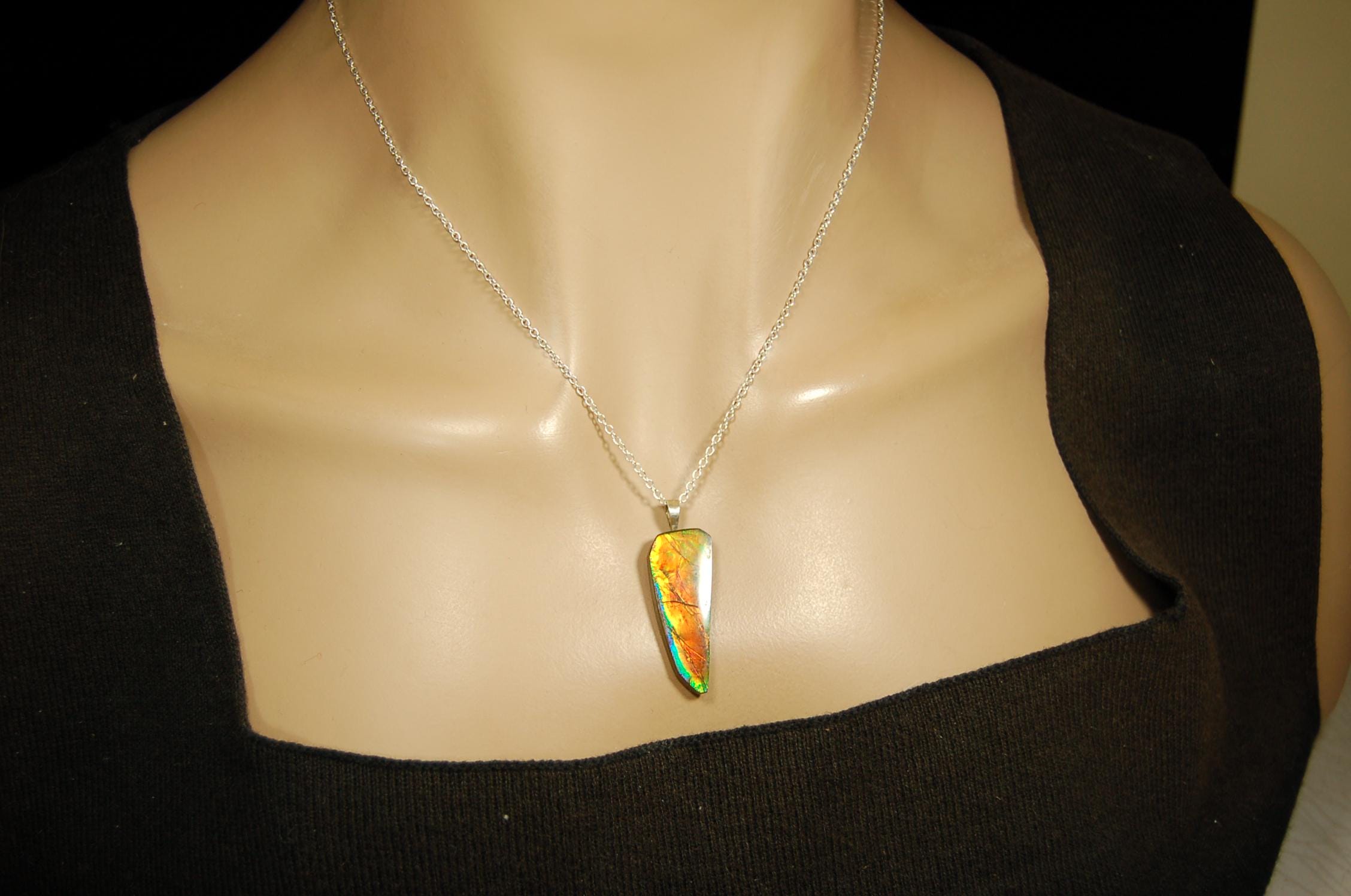 Ammolite necklace pendant.Natural rainbow cabochon of many bright colors.Strong color shifter.Video shows color best.030116