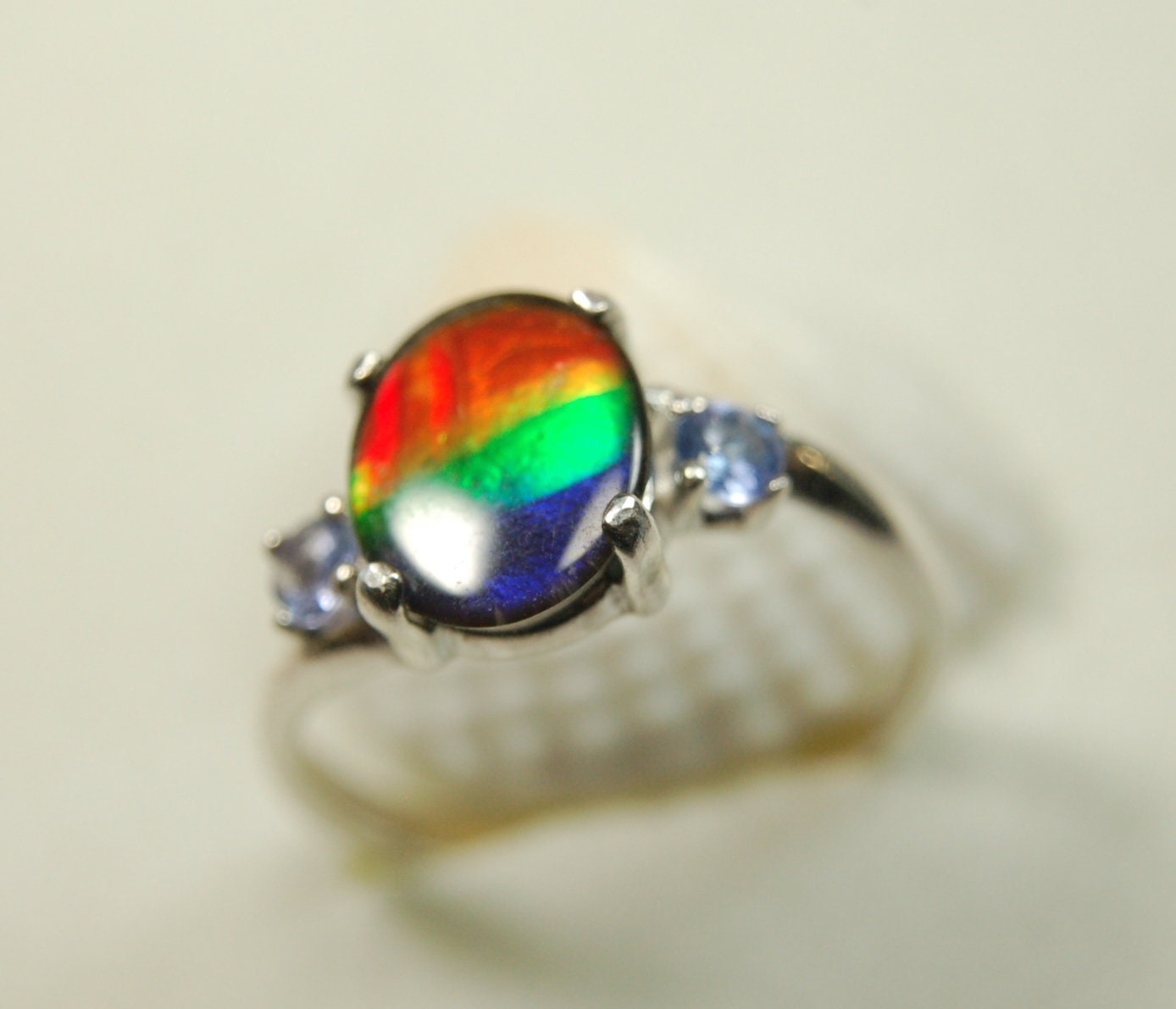 Ammolite Ring with brilliant colors and Tanzanite side stones.Size 7 #120223