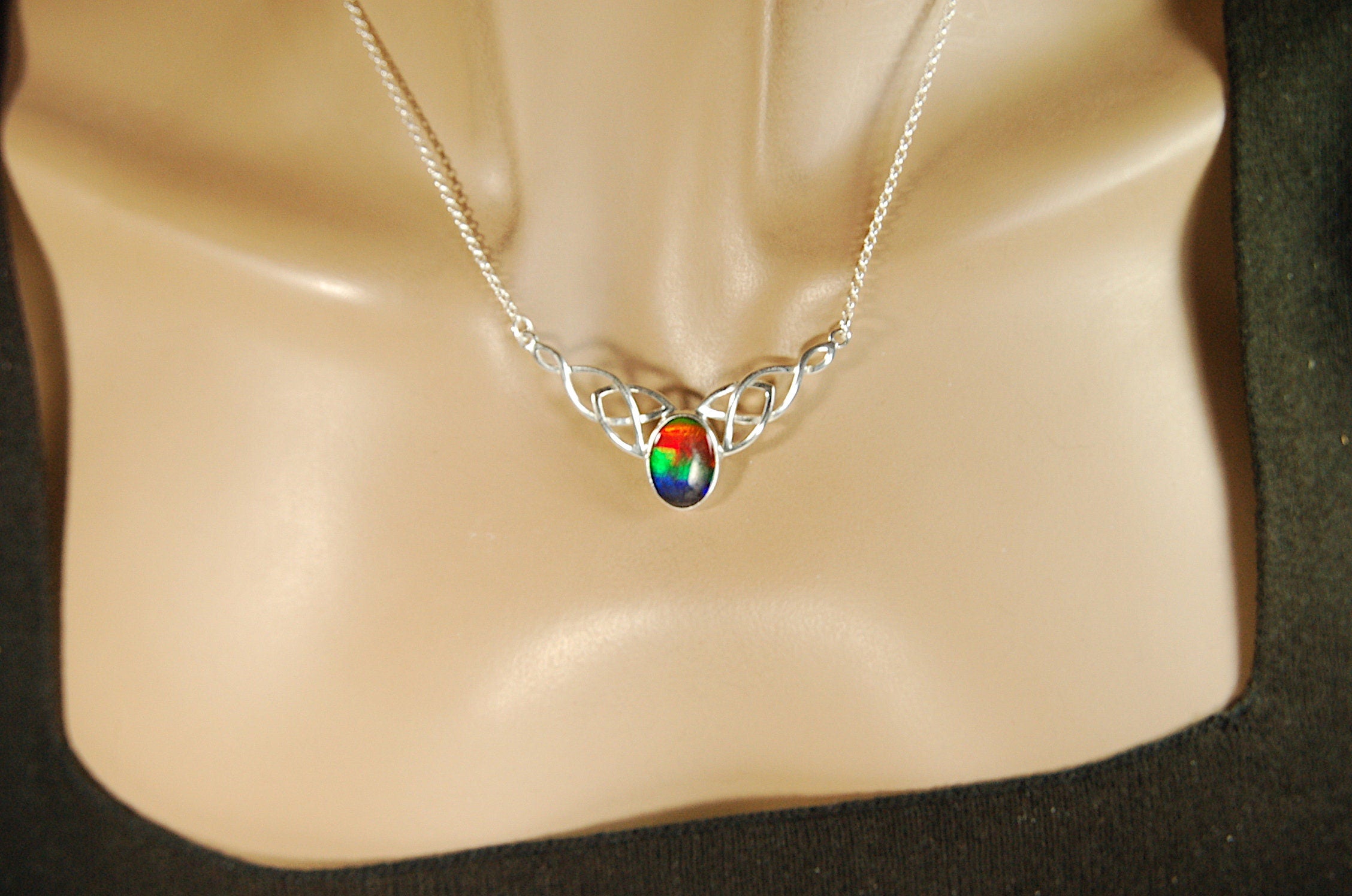Ammolite Jewelry Necklace of the much admired Rainbow type.Four colors. Lovely Celtic setting with extender.#042513