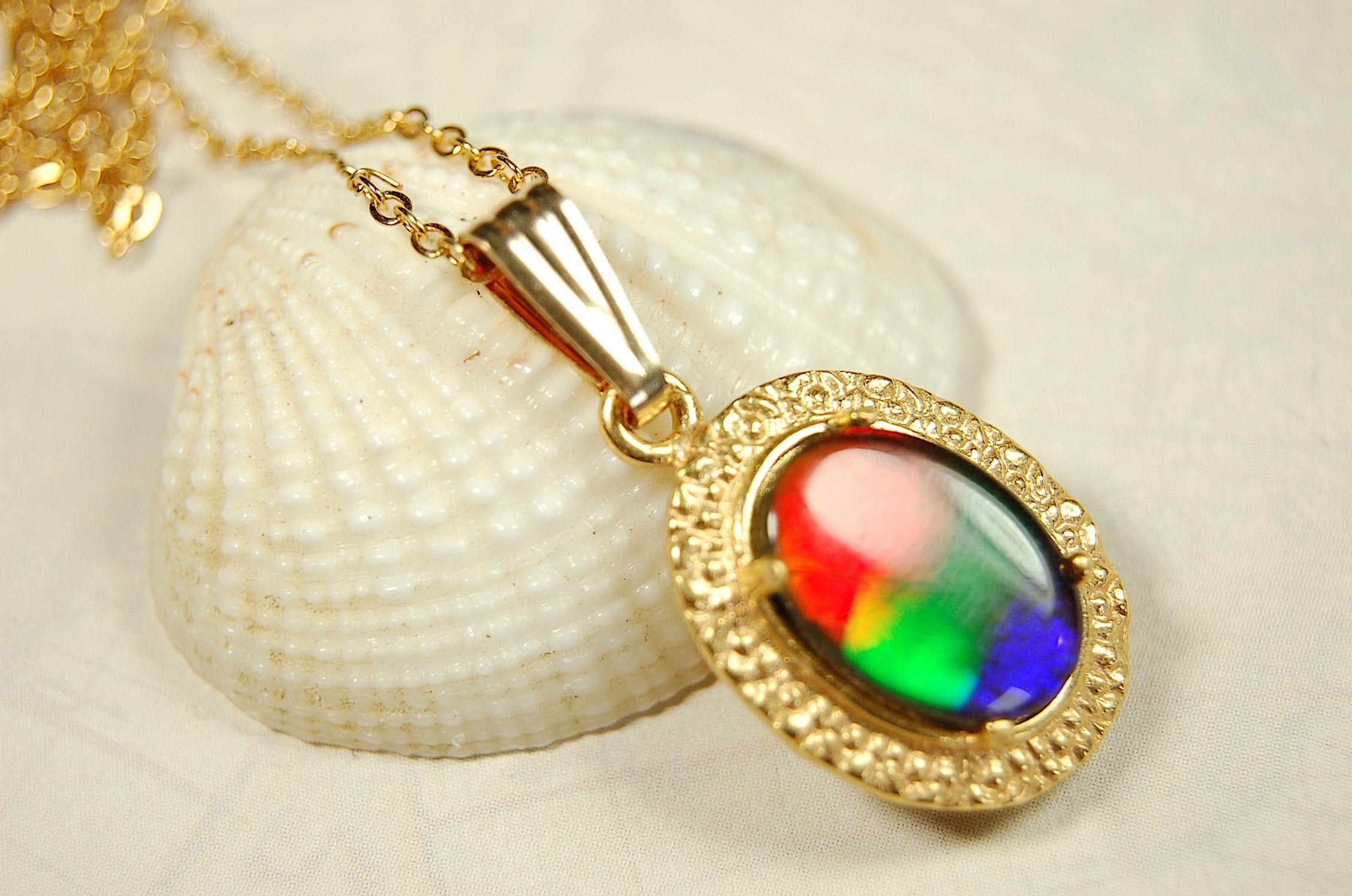 Genuine rainbow Ammolite pendant in 14k gold fill setting.#070414
