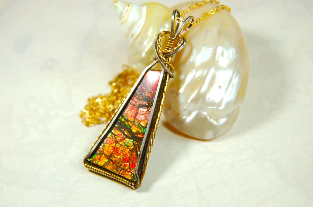 Unique Ammolite pendant set in Gold and sterling silver wire wrap.Natural cabochon in Canadian Maple fall colors.Must see video.082814