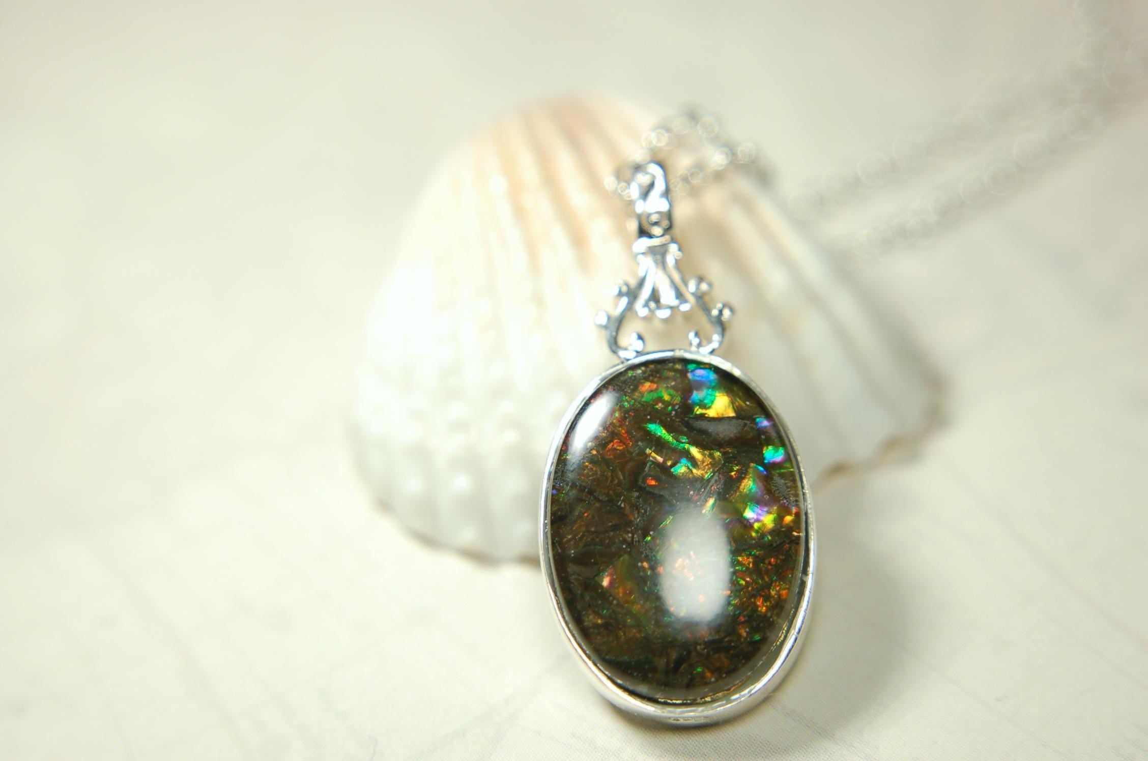 Ammolite Pendant.Rare sparks of color.Looks like a black Opal.One of a kind gem.Rare gift for her.Sterling Silver setting.022316