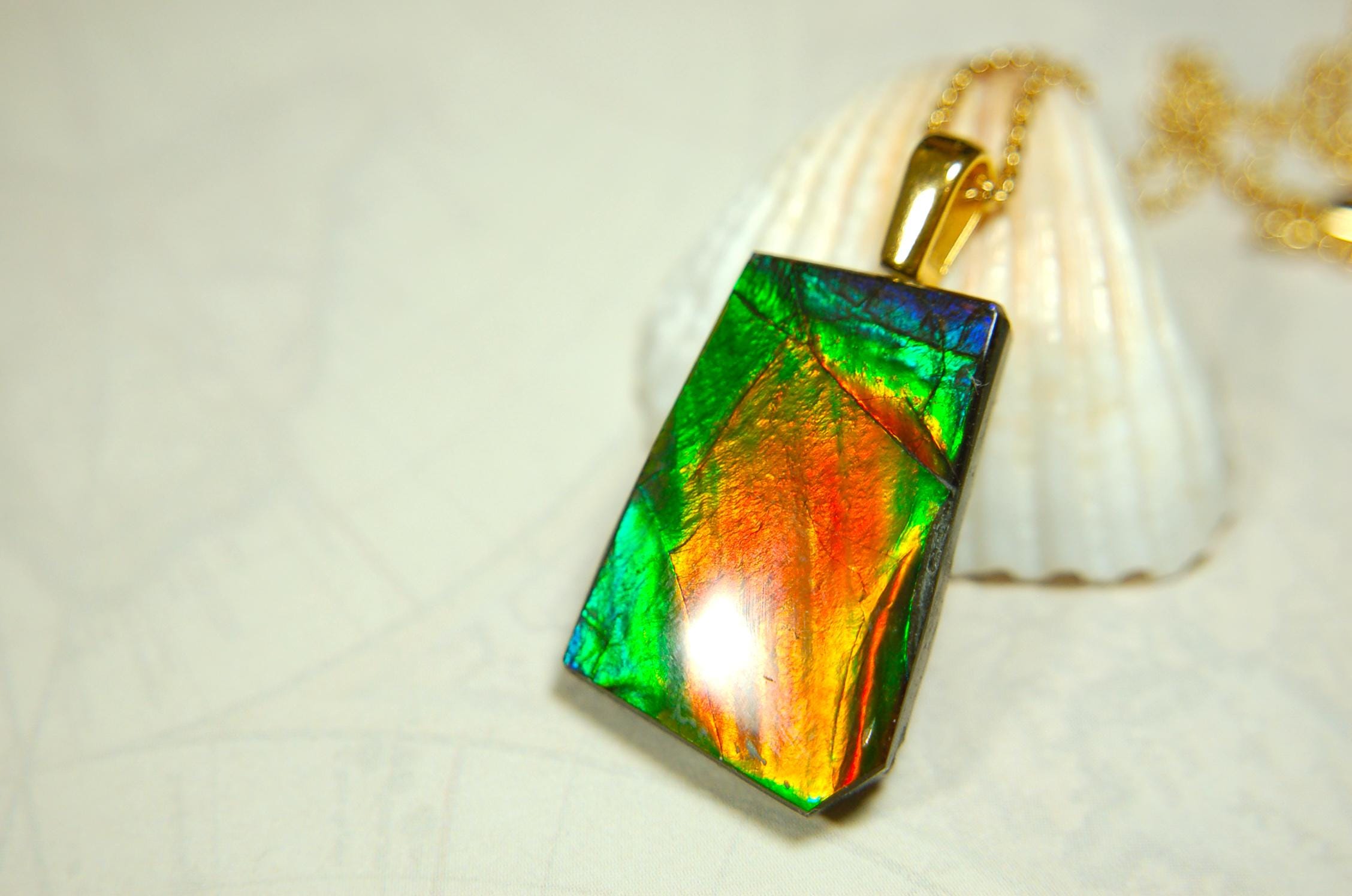Ammolite pendant.Vivid colors in a high quality all natural cabochon with 14k gold filled bail.Fine fashion jewelry accessory 022516