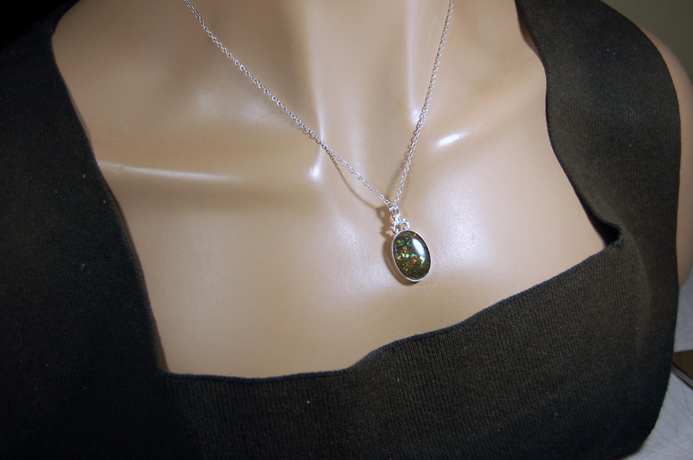 Ammolite Pendant.Rare sparks of color.Looks like a black Opal.One of a kind gem.Rare gift for her.Sterling Silver setting.022316