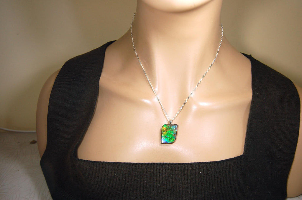 Ammolite Jewelry Pendant.Very high quality colors best seen in video.All natural cabochon gemstone from Alberta,Canada.031916
