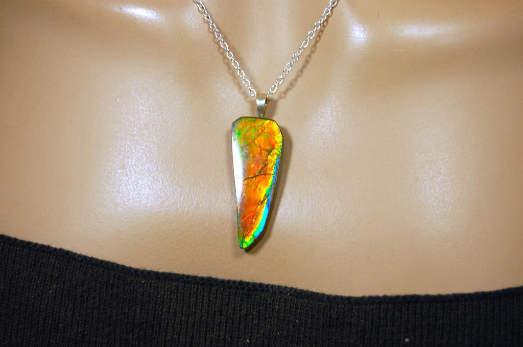 Ammolite necklace pendant.Natural rainbow cabochon of many bright colors.Strong color shifter.Video shows color best.030116