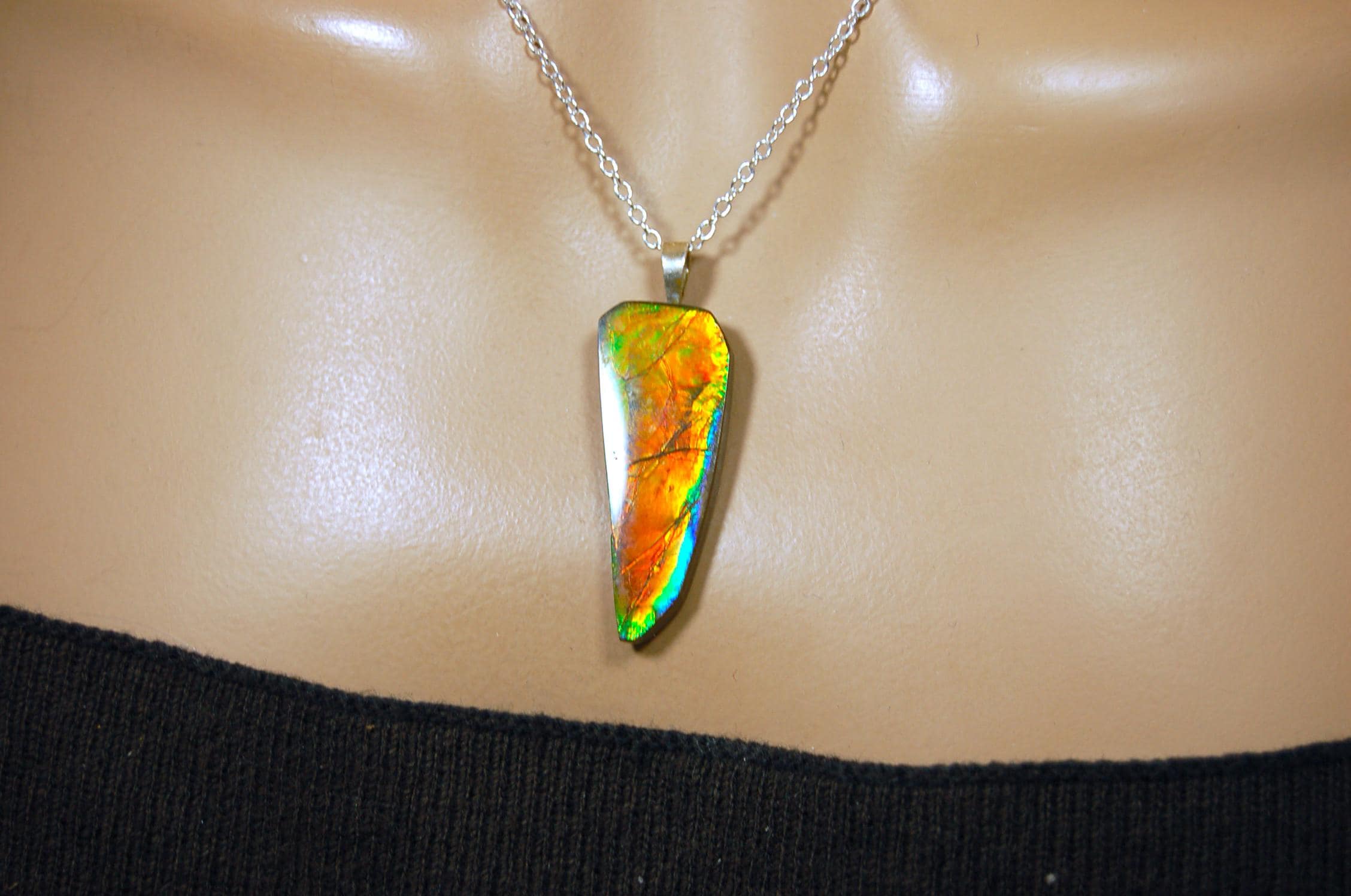 Ammolite necklace pendant.Natural rainbow cabochon of many bright colors.Strong color shifter.Video shows color best.030116