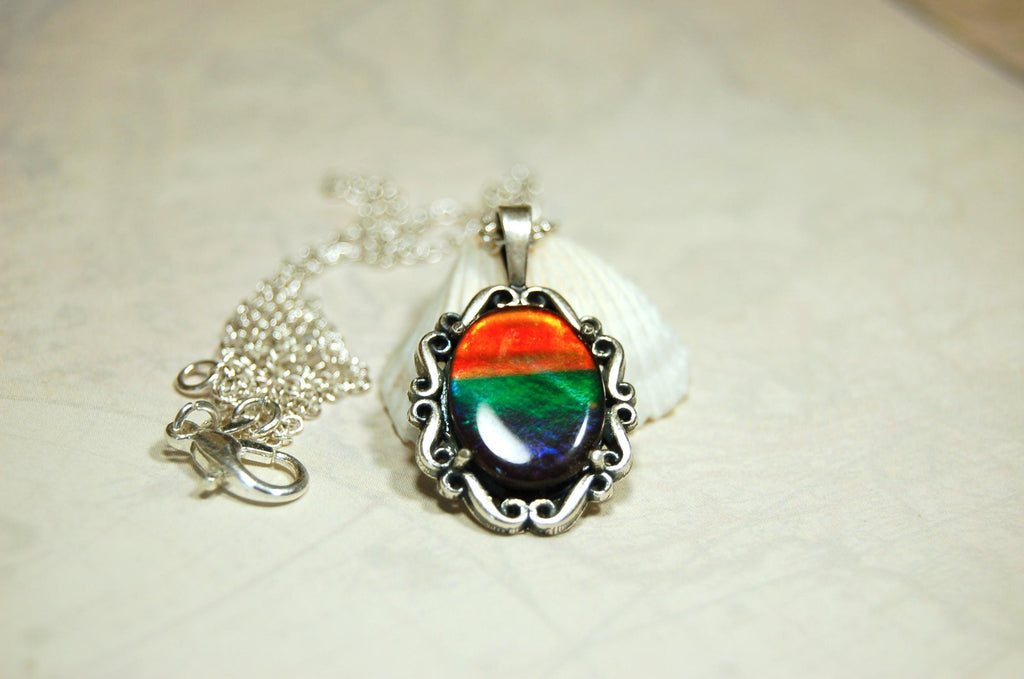 Genuine Ammolite Jewelry pendant with strong rainbow colors set in solid sterling silver.High Quality fashion accessory.