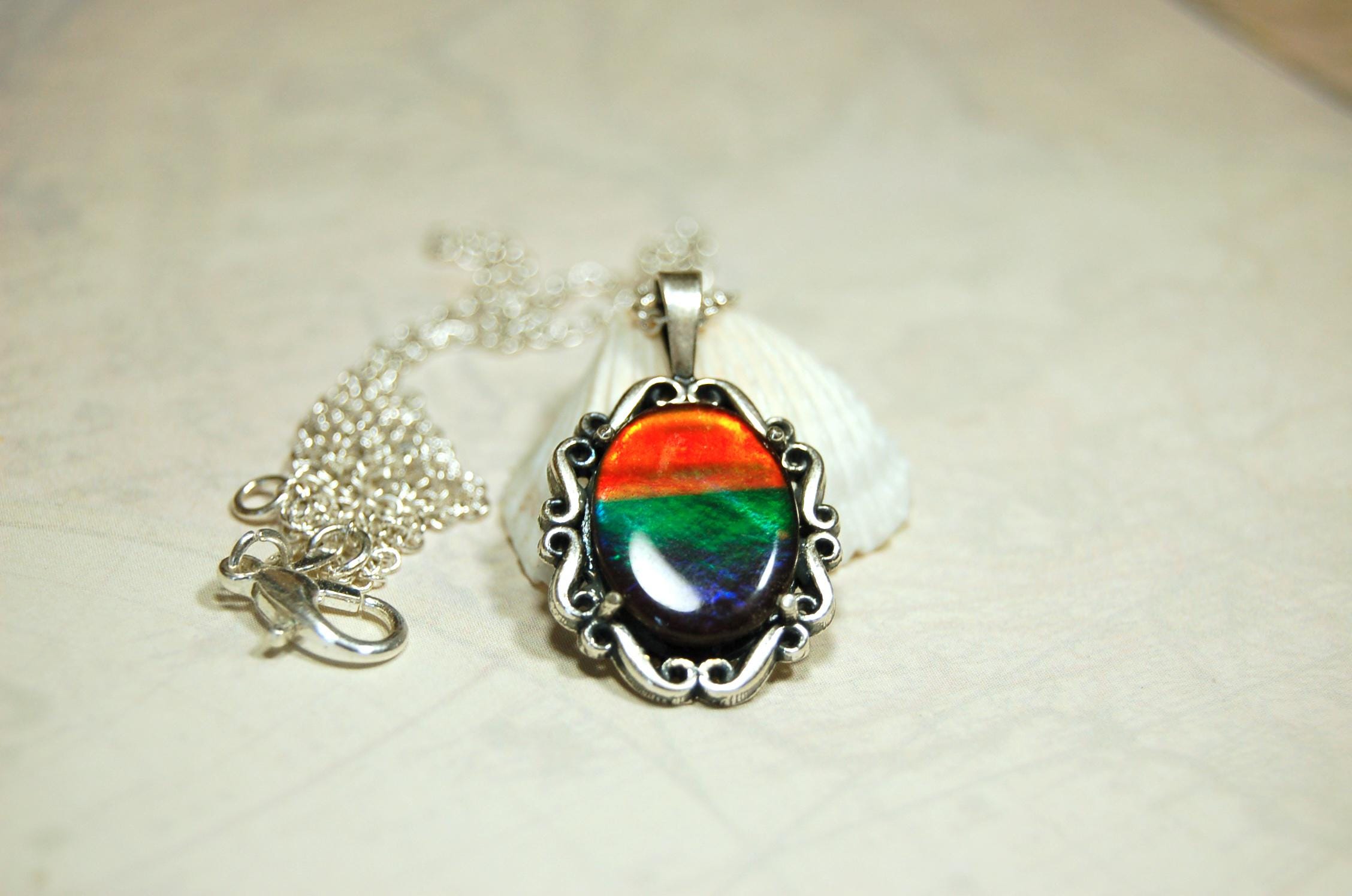 Genuine Ammolite Jewelry pendant with strong rainbow colors set in solid sterling silver.High Quality fashion accessory.