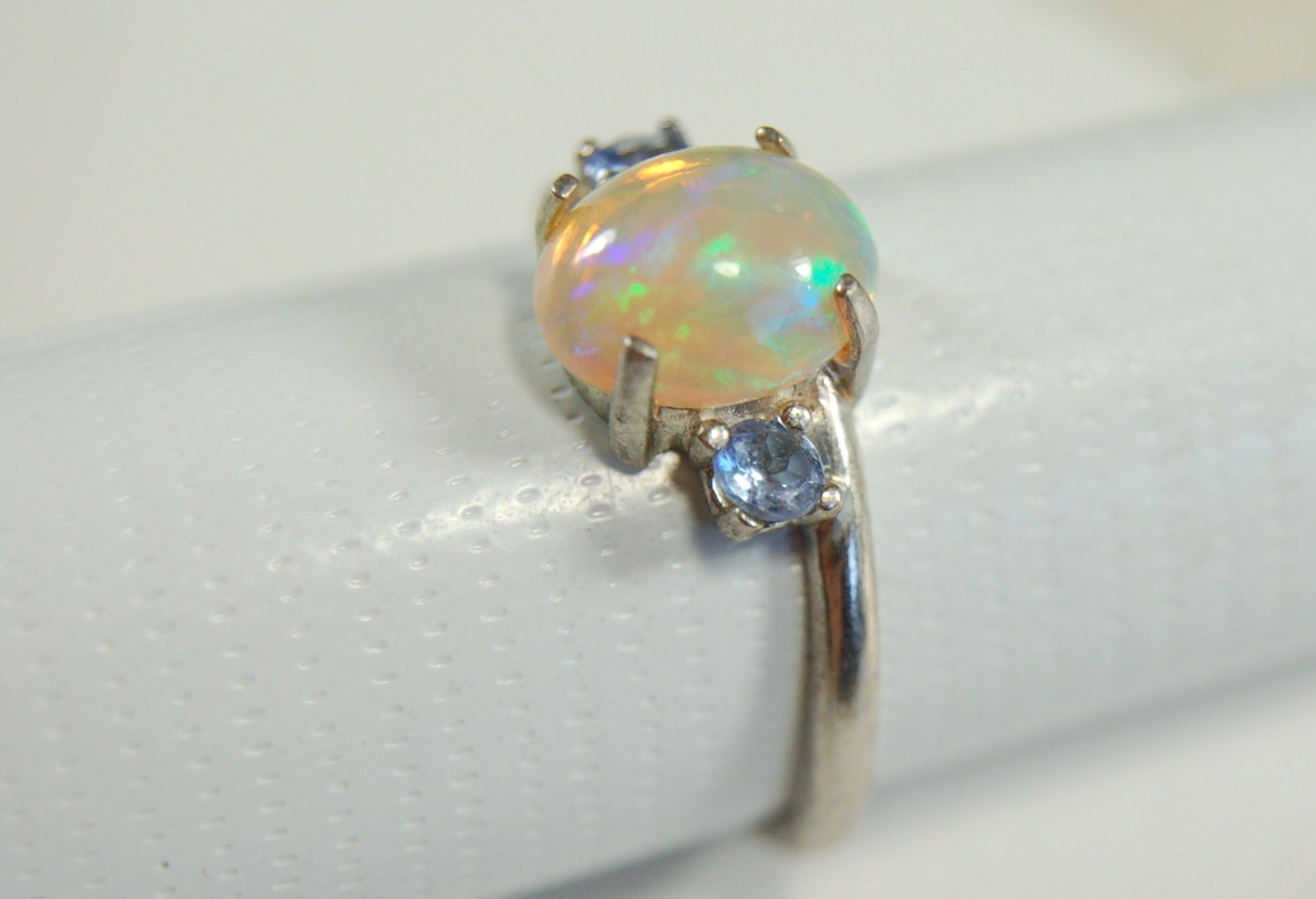 Opal ring.Solid African opal set in sterling silver with London Blue Topaz accent stones.Very feminine in size 6.