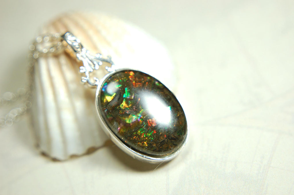 Ammolite Pendant.Rare sparks of color.Looks like a black Opal.One of a kind gem.Rare gift for her.Sterling Silver setting.022316