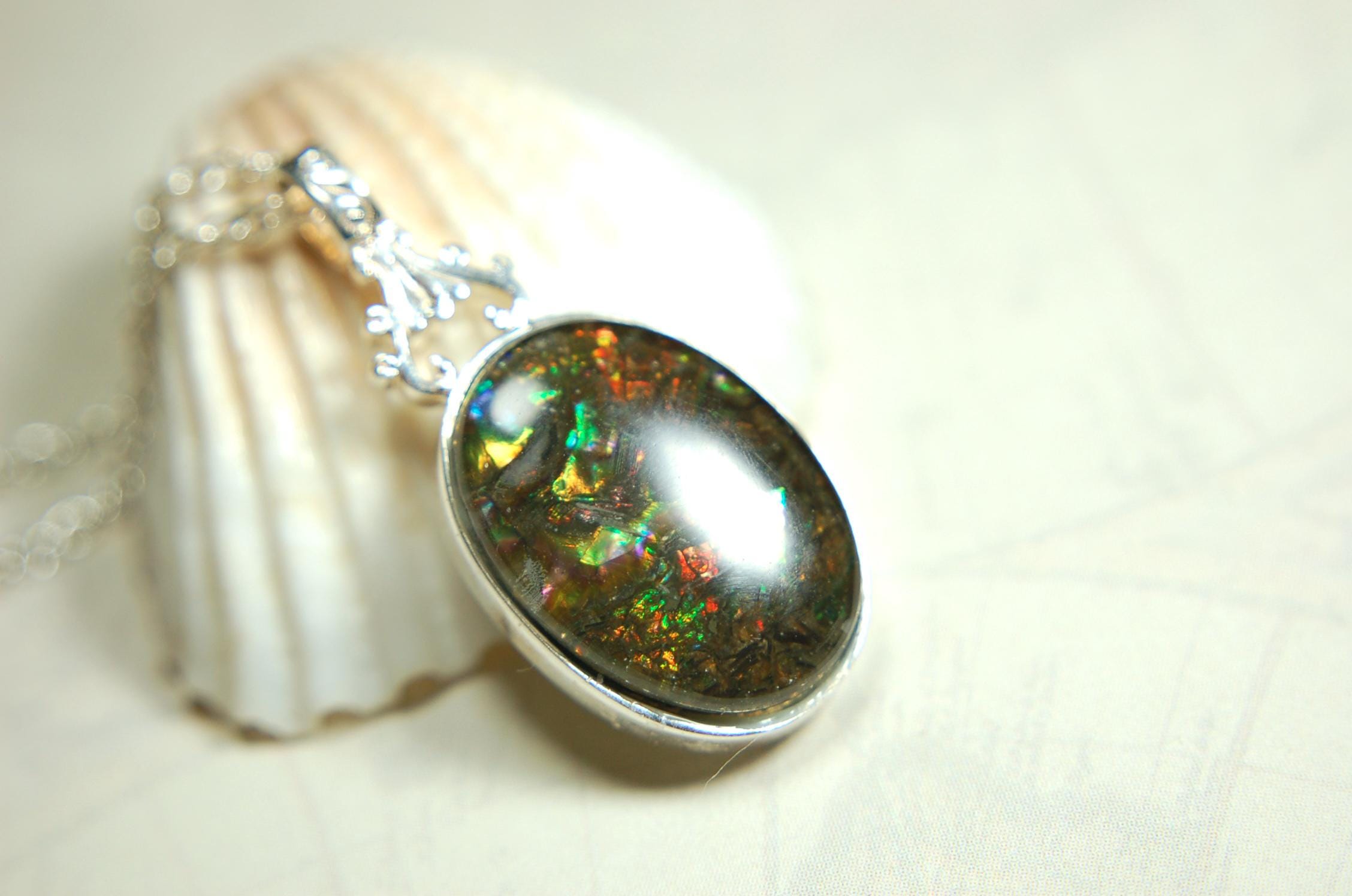 Ammolite Pendant.Rare sparks of color.Looks like a black Opal.One of a kind gem.Rare gift for her.Sterling Silver setting.022316