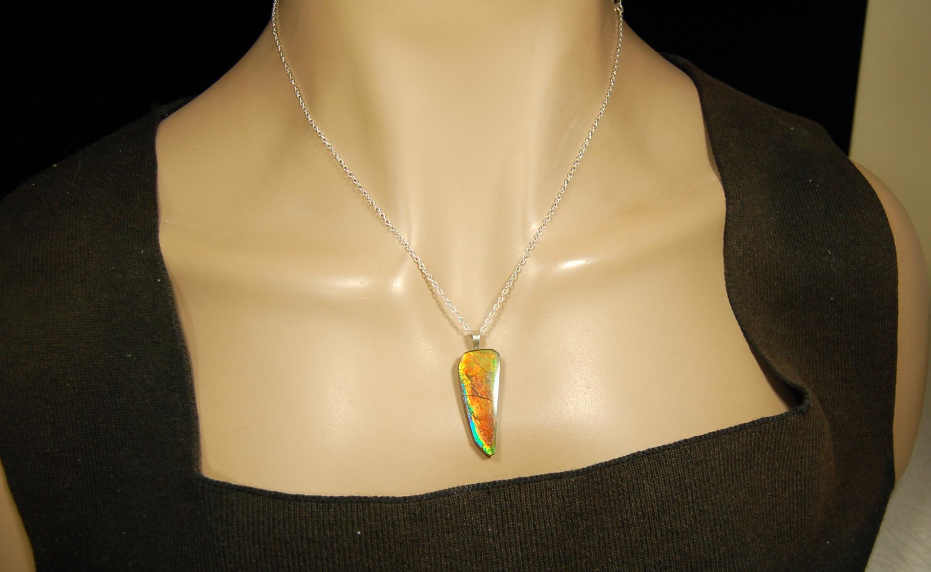 Ammolite necklace pendant.Natural rainbow cabochon of many bright colors.Strong color shifter.Video shows color best.030116