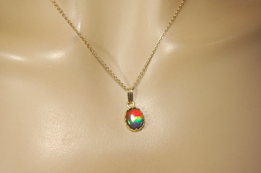 Gorgeous Ammolite pendant in 14k gold.Petite but powerful.Four color ammolite.Ammolite jewelry from Canada.Perfect gift. SEE VIDEO.060212