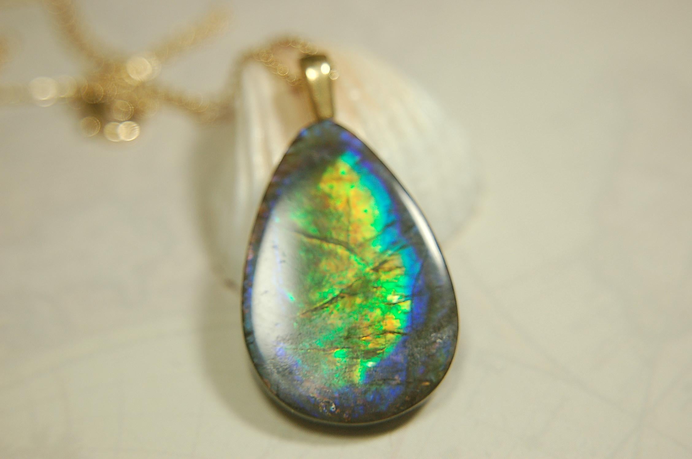 Ammolite Pendant with peacock colors.Natural cabochon gemstone mined and shipped from Canada.Gift of unique jewelry.MUST SEE VIDEO.020926