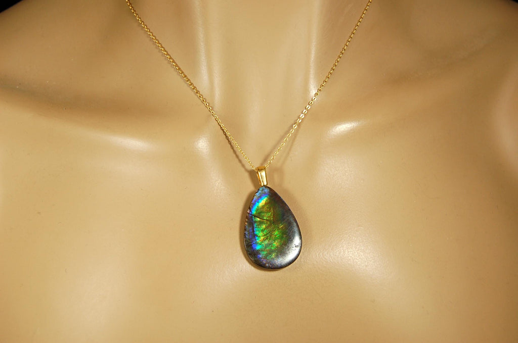 Ammolite Pendant with peacock colors.Natural cabochon gemstone mined and shipped from Canada.Gift of unique jewelry.MUST SEE VIDEO.020926