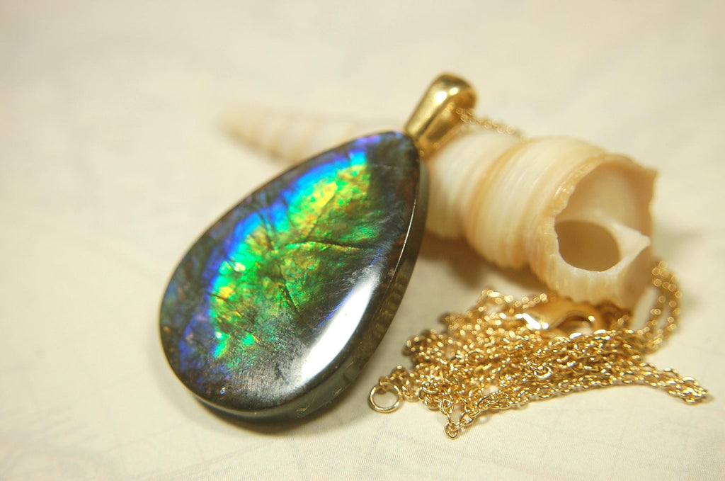 Ammolite Pendant with peacock colors.Natural cabochon gemstone mined and shipped from Canada.Gift of unique jewelry.MUST SEE VIDEO.020926