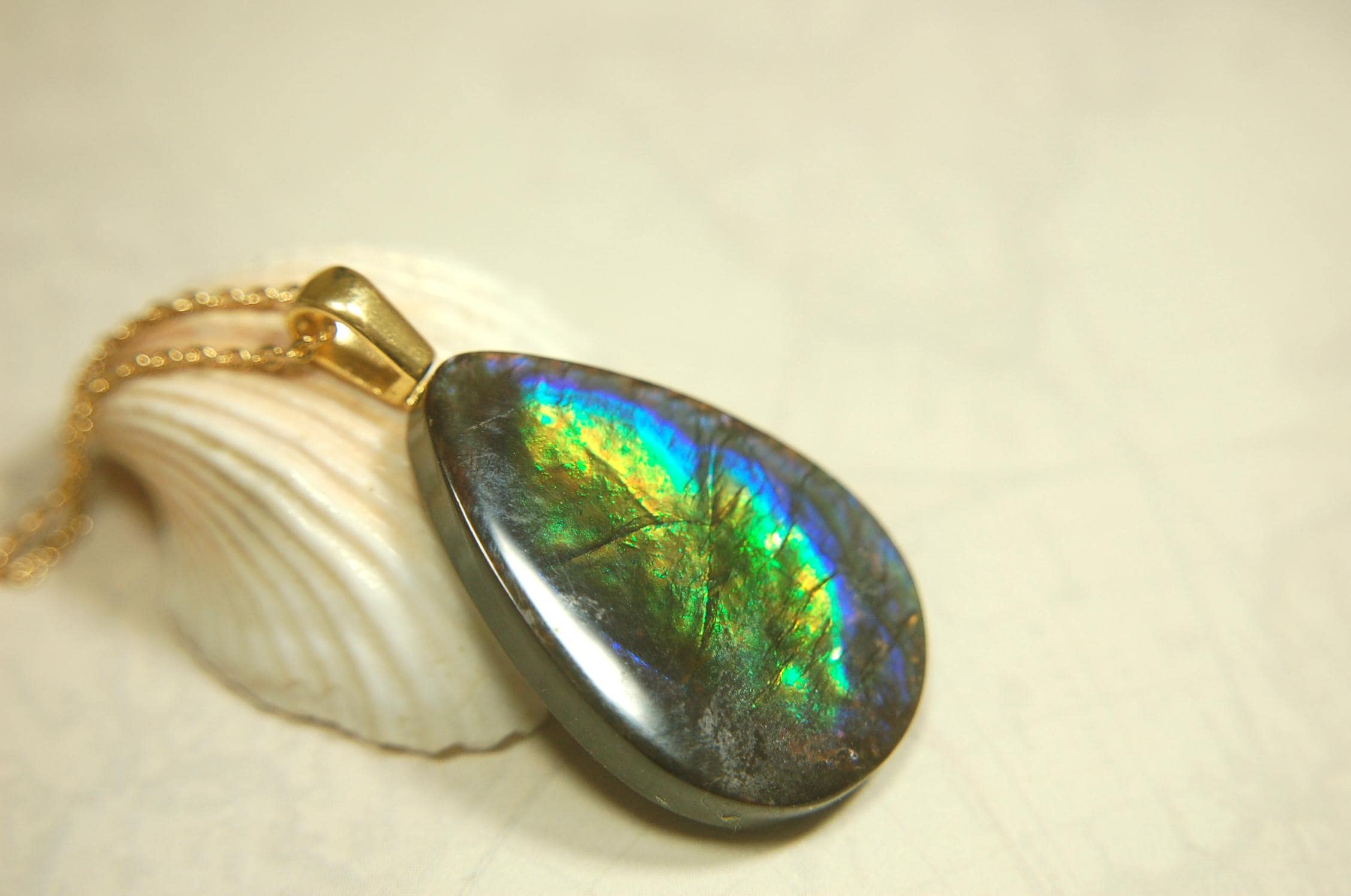 Ammolite Pendant with peacock colors.Natural cabochon gemstone mined and shipped from Canada.Gift of unique jewelry.MUST SEE VIDEO.020926