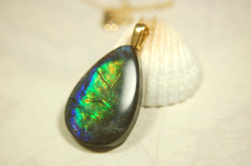 Ammolite Pendant with peacock colors.Natural cabochon gemstone mined and shipped from Canada.Gift of unique jewelry.MUST SEE VIDEO.020926