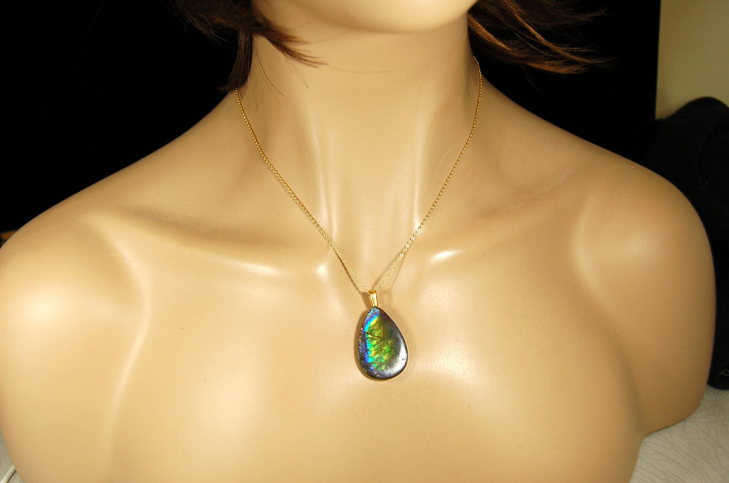 Ammolite Pendant with peacock colors.Natural cabochon gemstone mined and shipped from Canada.Gift of unique jewelry.MUST SEE VIDEO.020926