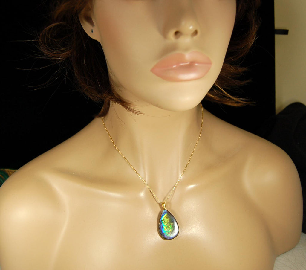 Ammolite Pendant with peacock colors.Natural cabochon gemstone mined and shipped from Canada.Gift of unique jewelry.MUST SEE VIDEO.020926