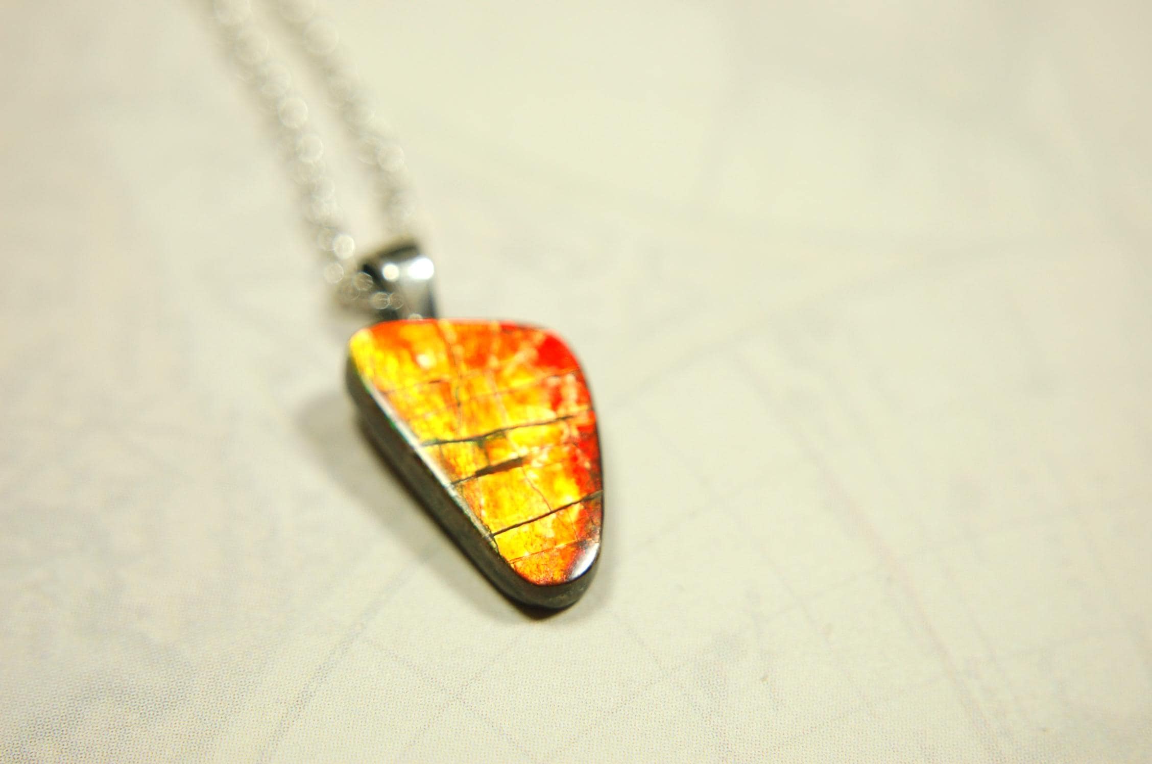 Ammolite Pendant with a gem of fire best appreciated in video.Amazing brilliance and hot colors.A big attention getter.022416
