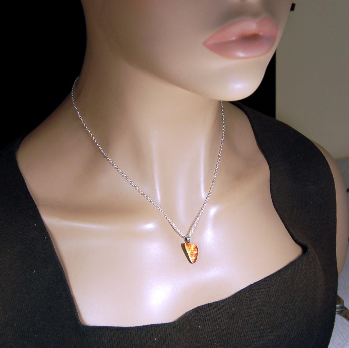 Ammolite Pendant with a gem of fire best appreciated in video.Amazing brilliance and hot colors.A big attention getter.022416