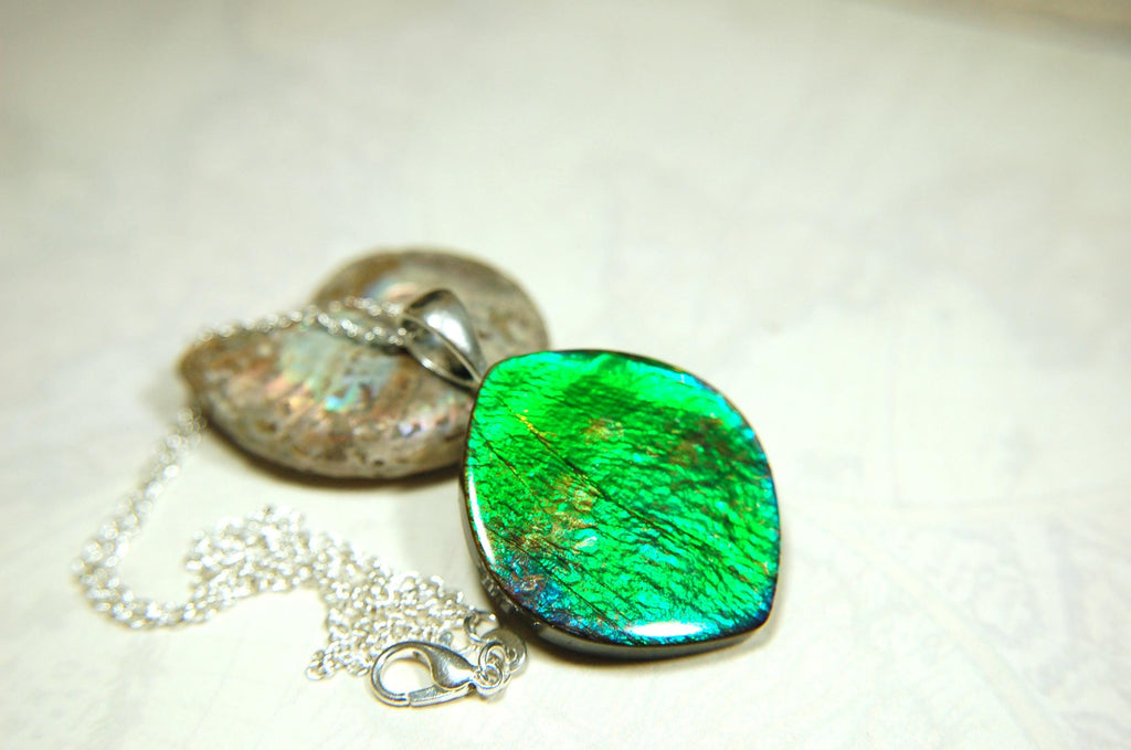 Ammolite pendant for lovers of green this is the one.High quality genuine gem from Alberta Canada.Big impact pendant.021226