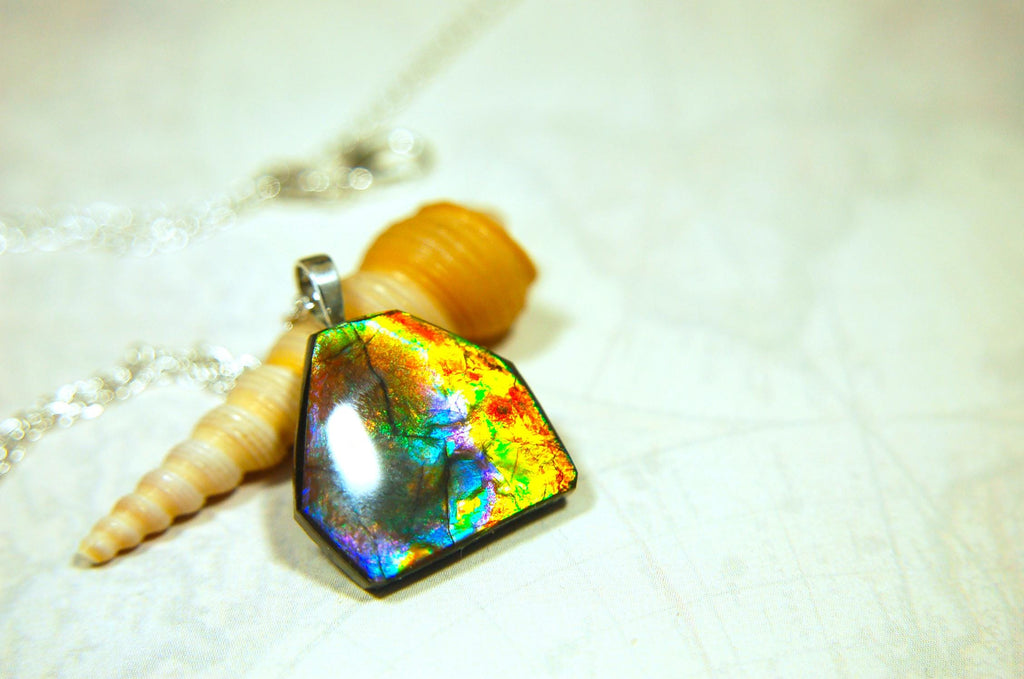 Ammolite pendant.RARE colors.Best seen in video.All natural cabochon from Alberta Canada.Thoughtful gift for her.022716