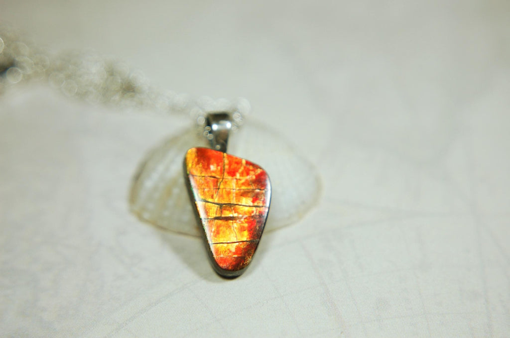 Ammolite Pendant with a gem of fire best appreciated in video.Amazing brilliance and hot colors.A big attention getter.022416