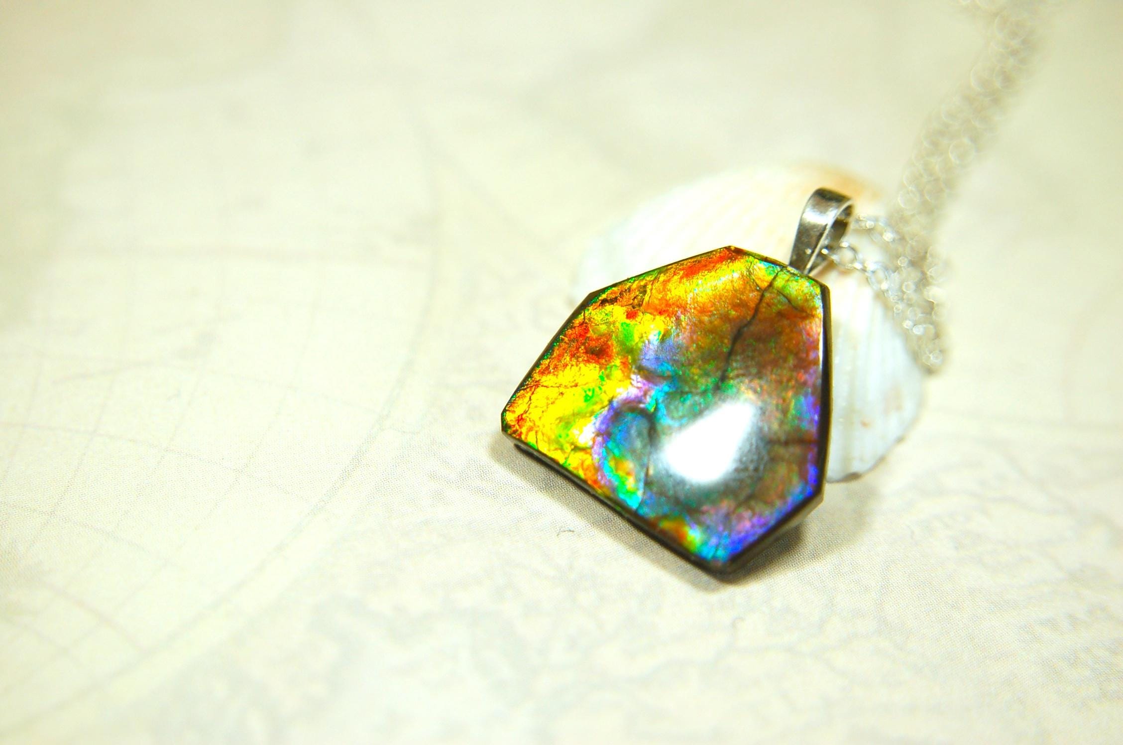 Ammolite pendant.RARE colors.Best seen in video.All natural cabochon from Alberta Canada.Thoughtful gift for her.022716