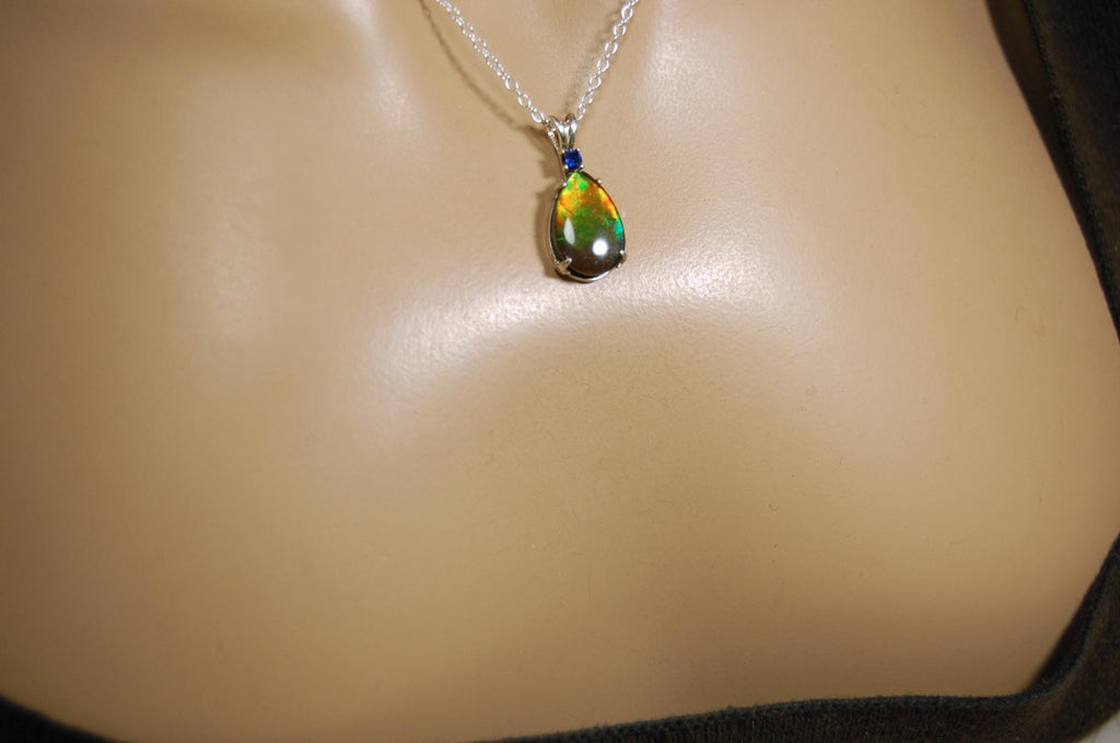 Sterling Silver set Ammolite Pendant with blue Sapphire.A gift idea for your wife she will treasure.Must see video.060916