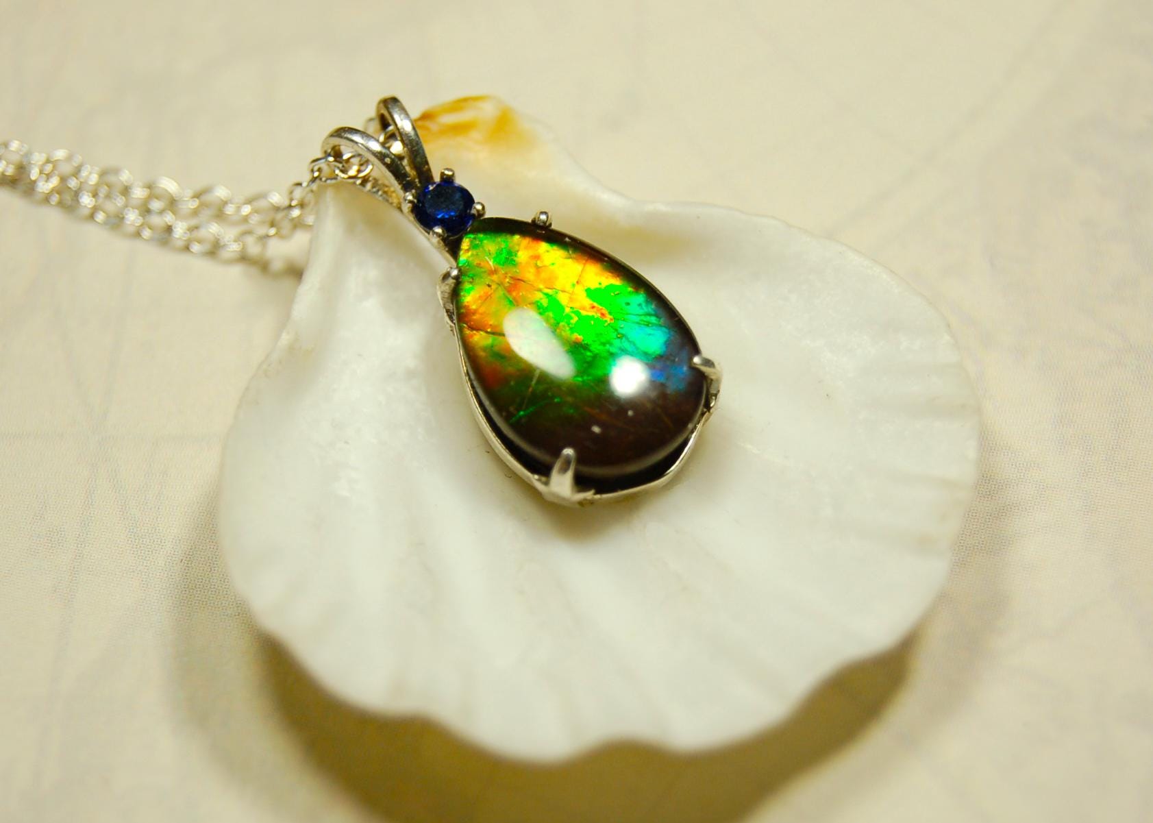 Sterling Silver set Ammolite Pendant with blue Sapphire.A gift idea for your wife she will treasure.Must see video.060916