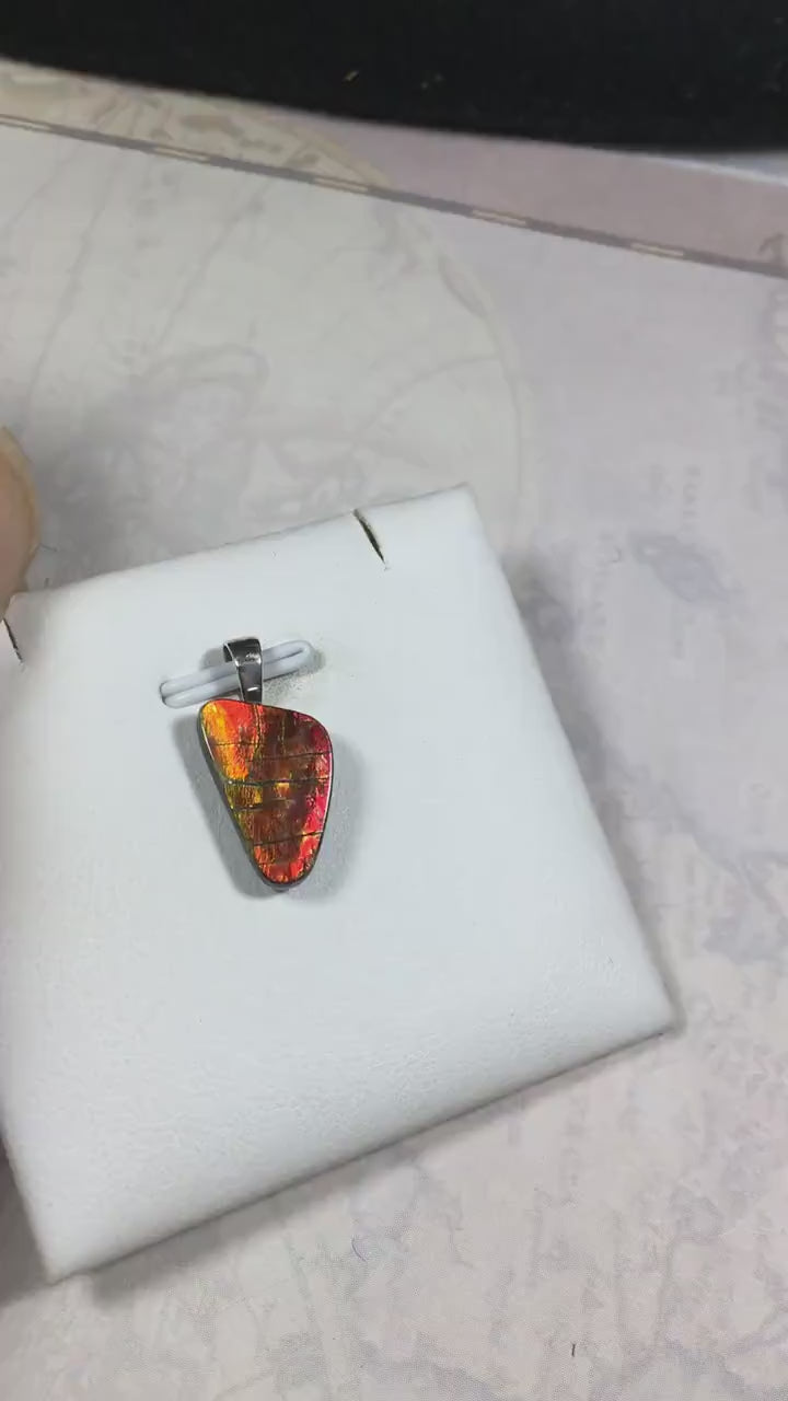 Ammolite Pendant with a gem of fire best appreciated in video.Amazing brilliance and hot colors.A big attention getter.022416