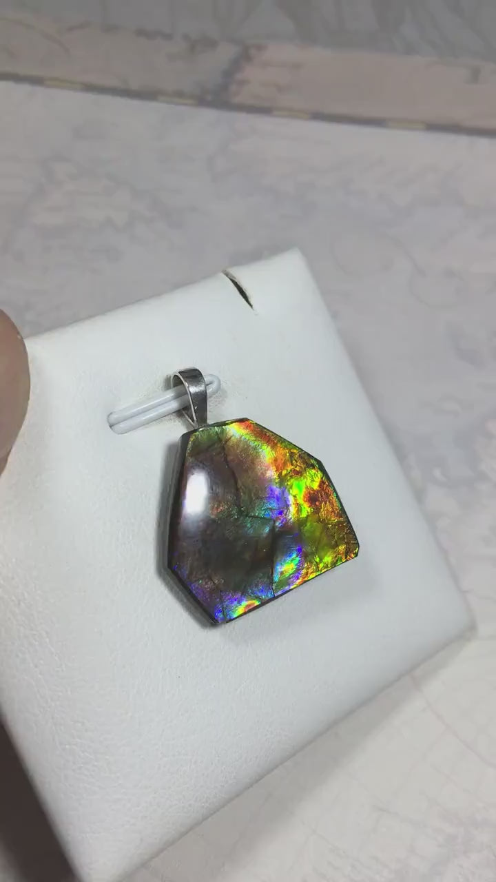 Ammolite pendant.RARE colors.Best seen in video.All natural cabochon from Alberta Canada.Thoughtful gift for her.022716