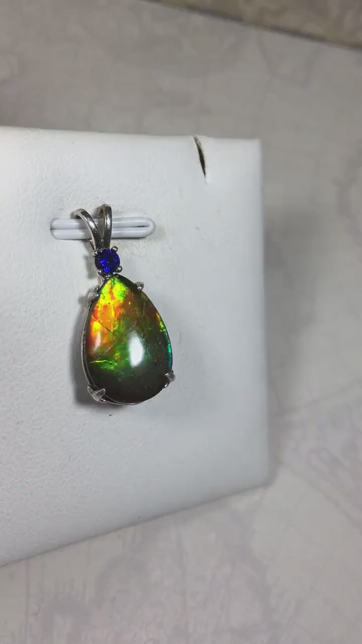 Sterling Silver set Ammolite Pendant with blue Sapphire.A gift idea for your wife she will treasure.Must see video.060916