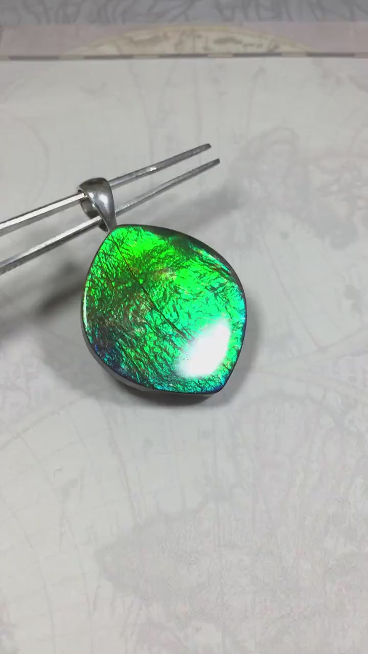 Ammolite pendant for lovers of green this is the one.High quality genuine gem from Alberta Canada.Big impact pendant.021226