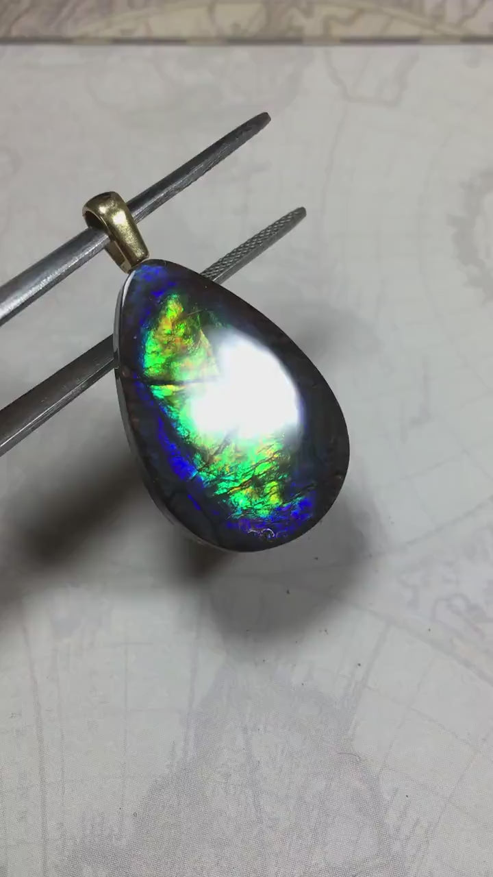 Ammolite Pendant with peacock colors.Natural cabochon gemstone mined and shipped from Canada.Gift of unique jewelry.MUST SEE VIDEO.020926